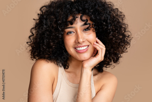 Radiant smile - curly haired woman portrait