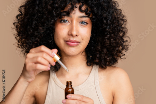 woman applying facial oil for skincare routine