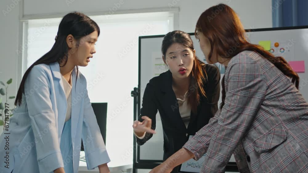 Professional businesswomen collaborate in a modern office, discussing documents and charts, working on a project in slow motion Professional businesswomen collaborate in a modern office, discussing documents and charts, working on a project in slow motion