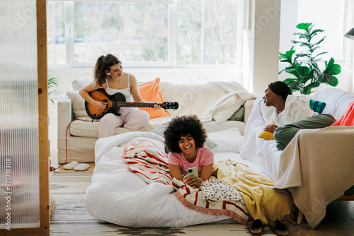 Best friends enjoying a relaxing day indoors with music photo