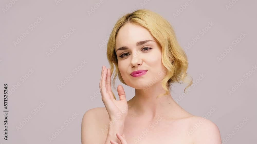Beautiful young woman touching her perfect skin. Natural cosmetic skin care products. A woman demonstrates moisturizing facial care. Beautiful young woman touching her perfect skin. Natural cosmetic skin care products. A woman demonstrates moisturizing facial care.