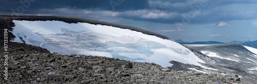 View from Bolnatind, on the arctic circle in Helgeland, Norway. Cloudy day in the norwegian fjell. High resolution panoramas of saltfjellet and Svartisen Nasjonalpark. Glacier and mountains photo