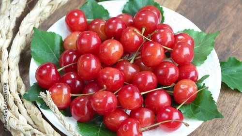 Top view Rotate Red Cherry fruit on wooden background, Japanese Red highest variety of Yamagata cherries on white table.