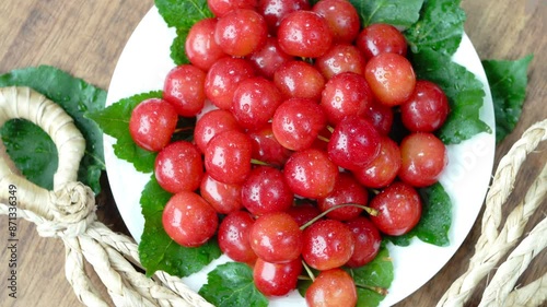 Top view Rotate Red Cherry fruit on wooden background, Japanese Red highest variety of Yamagata cherries on white table.