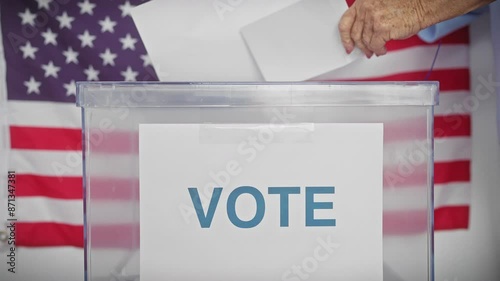 Senior woman voting in the usa election, at a polling station with american flags. photo