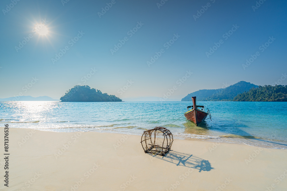 Beautiful clean white beach with long tail boats or fishing boats docked on the beach of Japanese Island, Ranong Province, southern Thailand, Asia. Beautiful clean white beach with long tail boats or fishing boats docked on the beach of Japanese Island, Ranong Province, southern Thailand, Asia.