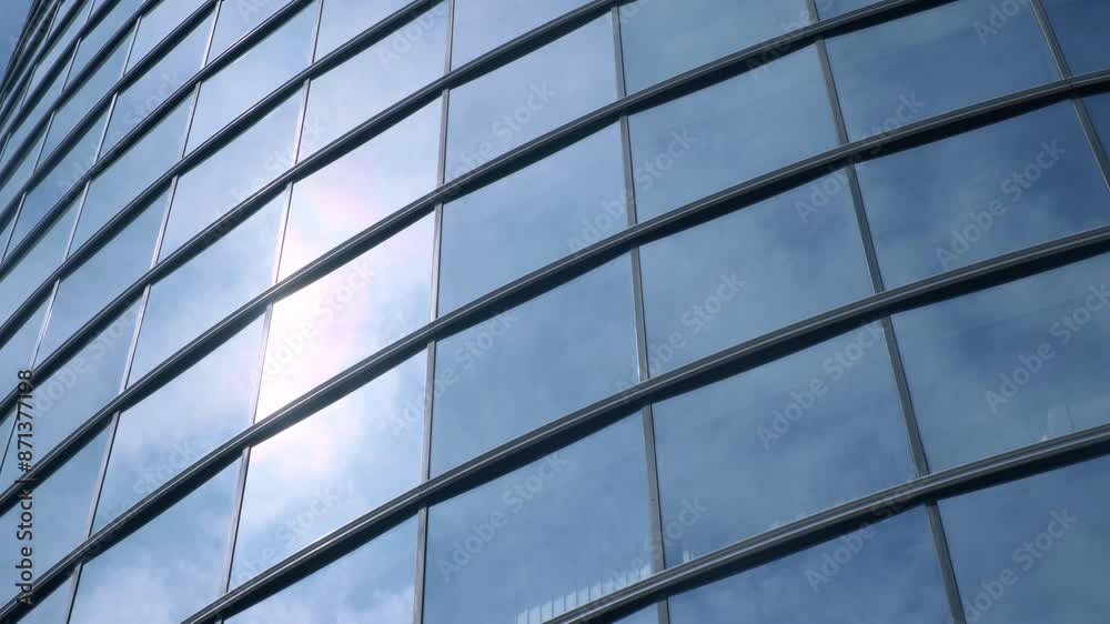 Modern walls are made of glass and steel with reflections of buildings, sunlight and sky. Modern walls are made of glass and steel with reflections of buildings, sunlight and sky.