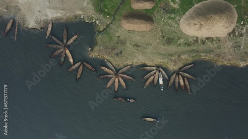 aerial view of wooden boats, arranged in a flower pattern, floating on a majestic river. photo