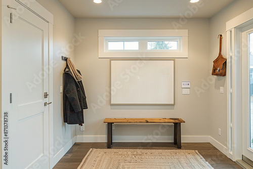 Modern entryway with white board beside coat rack