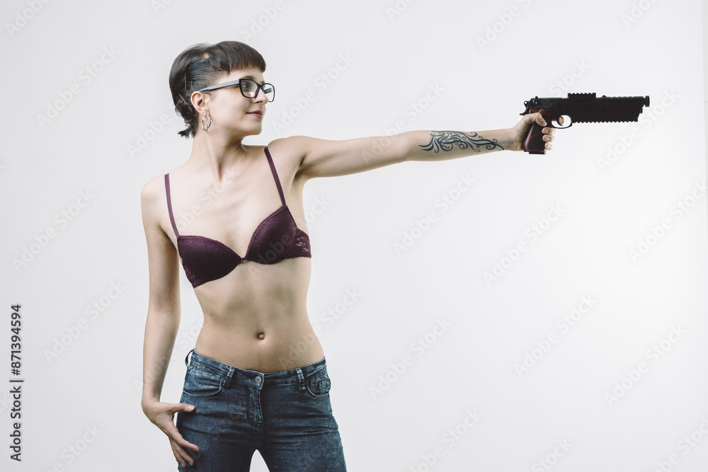 Lingerie-clad woman with gun, vigilant and seductive Lingerie-clad woman with gun, vigilant and seductive