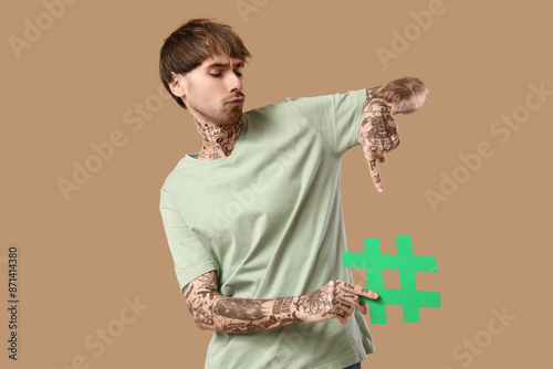 Cool tattooed young man wit...