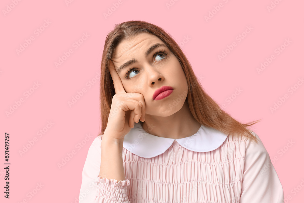 Thoughtful young woman trying to remember something on pink background. Reminder concept Thoughtful young woman trying to remember something on pink background. Reminder concept