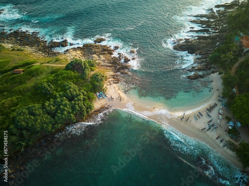 A tiny sand beach spit between the green paradise peninsula and tropical coastline of Sri Lanka