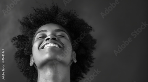 Black and white portrait of smiling woman.