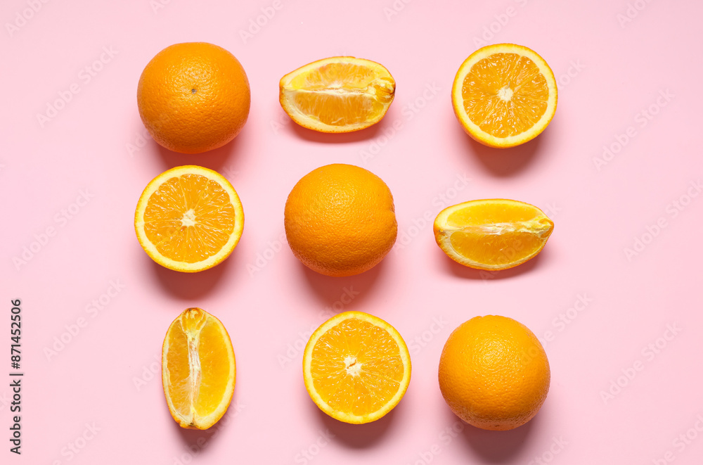 Fototapeta premium Beautiful composition with tasty oranges on pink background