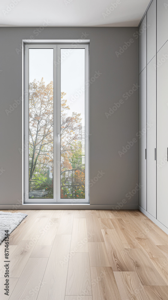 Fototapeta premium Wardrobe in an empty room with minimal, neutral colors and filled with lighting coming from a window. Residential Real Estate interiors design composition.