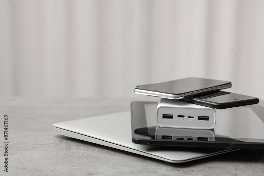 Stack on modern gadgets on grunge table indoors Stack on modern gadgets on grunge table indoors