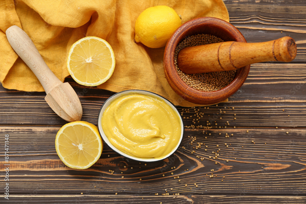 Bowl of creamy mustard and lemon on brown wooden background Bowl of creamy mustard and lemon on brown wooden background