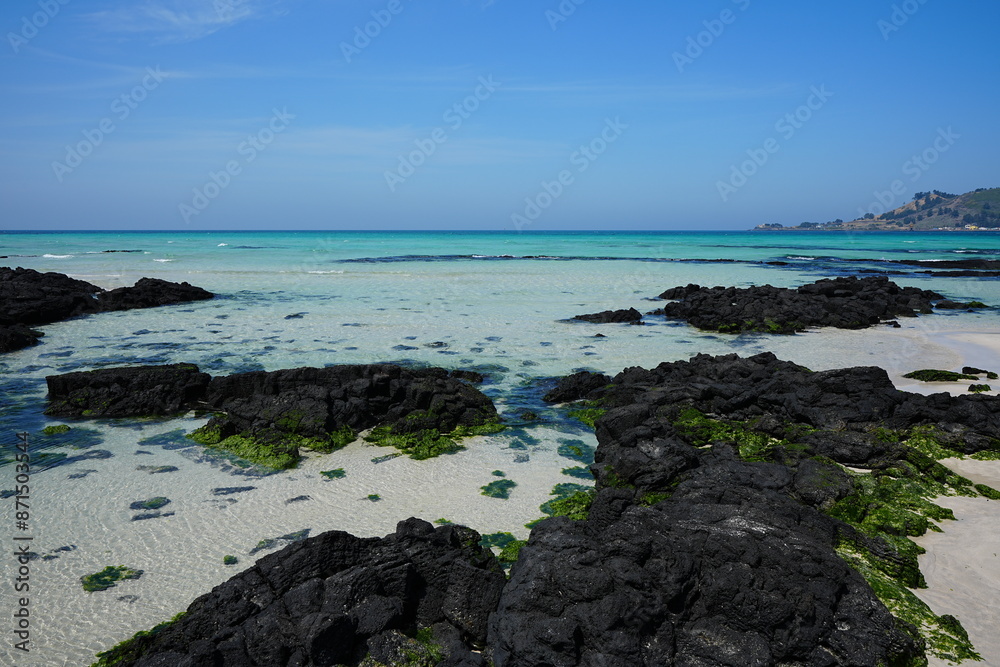 clear rock beach and far island clear rock beach and far island