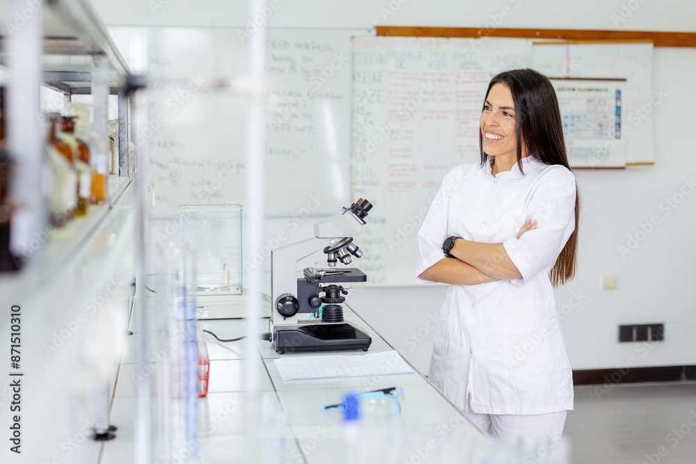 Young scientist smiling in a laboratory wearing a coat Young scientist smiling in a laboratory wearing a coat