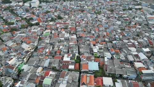 Pan Up Over Sunter Lake Slums Looking Back At Jakarta Central City Indonesia photo