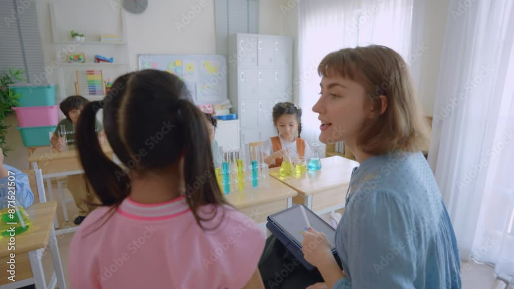 Adorable student learn with teacher in classroom at elementary school. Adorable student learn with teacher in classroom at elementary school.