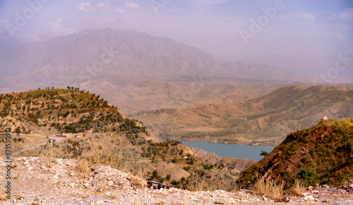 A mountain range with a lake in the distance photo