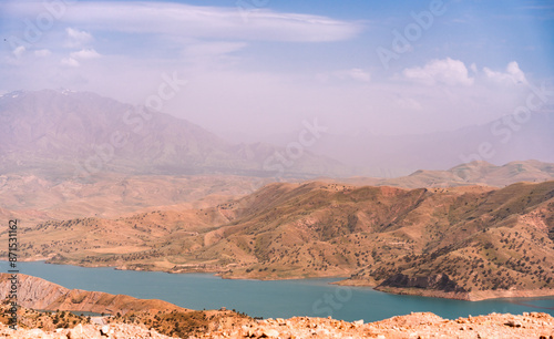 A mountain range with a lake in the foreground photo