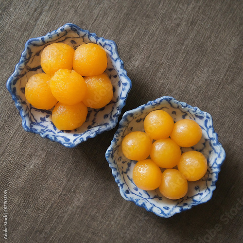 Thong Yip and Thong Yod are auspicious traditional Thai desserts known for their distinctive yellow color. They are made from egg yolks that are beaten until fluffy and then dropped into syrup to form