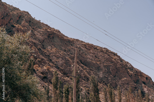 A mountain with a power line running up it photo