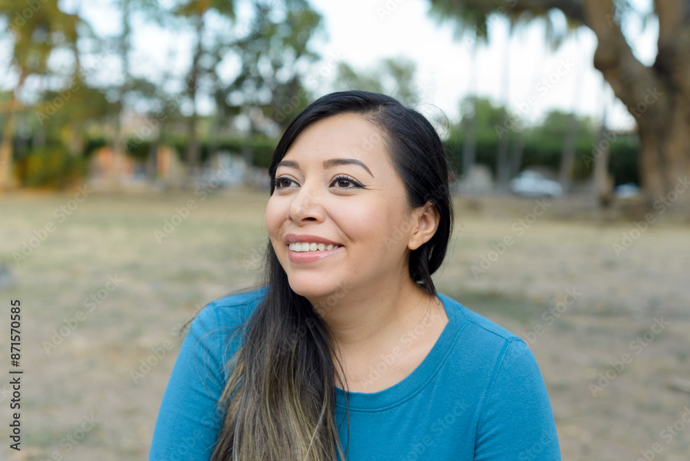 Woman in a public park with positive attitude, smiling. Woman in a public park with positive attitude, smiling.