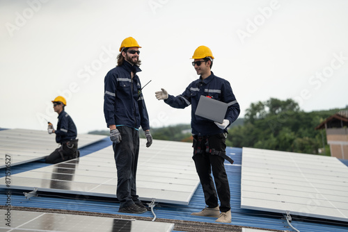 Wallpaper Mural Engineer team checking solar cell or photovoltaic cell by computer laptop installed on the roof of the factory. Technician worker repair or inspect the system. Industrial renewable energy concept Torontodigital.ca