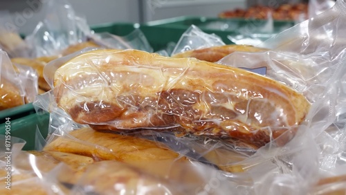 Freshly boiled pork ribs, vacuum sealed in clear plastic, showcasing preservation and readiness for retail.