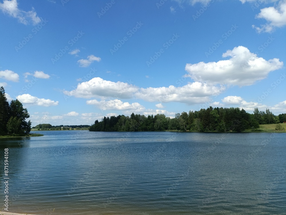 Bubiai lake during sunny day. Lake with small waves. Sunny day with white and gray clouds in sky. Nature. Bubiu ezeras. Bubiai lake during sunny day. Lake with small waves. Sunny day with white and gray clouds in sky. Nature. Bubiu ezeras.