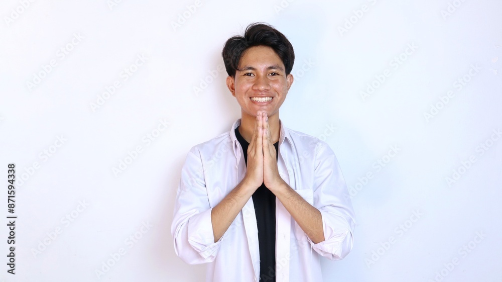 Young smiling Asian man gesturing welcome Young smiling Asian man gesturing welcome