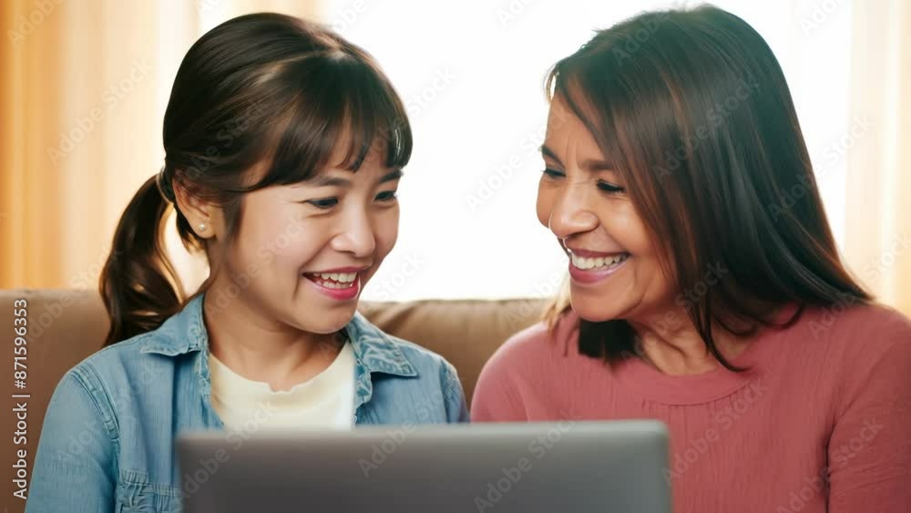 Two Women Sharing a Moment with a Laptop Two Women Sharing a Moment with a Laptop