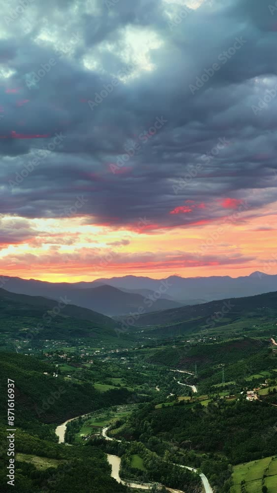 Aerial, drone view of mountains and green fields in North Macedonia at sunset. Vertical Aerial, drone view of mountains and green fields in North Macedonia at sunset. Vertical
