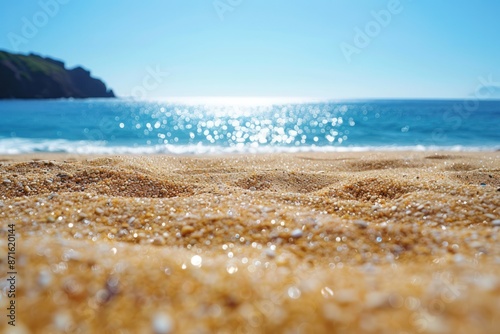 A beach with a clear blue ocean and a sandy shore