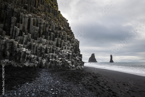 Reynisfjara beac h with view to parts of Reynisdrangar in south iceland near vik i myrdal in moody weather in summer