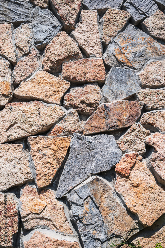 texture of the masonry of a modern stone wall made of multicolored stones in close-up texture of the masonry of a modern stone wall made of multicolored stones in close-up