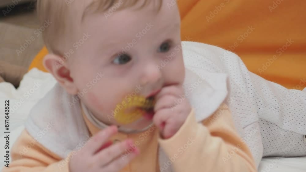 Adorable happy blonde infant baby playing with kids toys at home while sitting on carpet floor in living room. Portrait of smiling cute child toddler using colorful toys, copy space Adorable happy blonde infant baby playing with kids toys at home while sitting on carpet floor in living room. Portrait of smiling cute child toddler using colorful toys, copy space