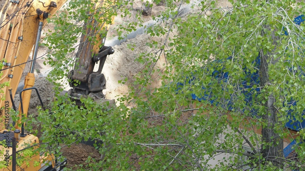 A tractor and an excavator transport construction materials for road construction. Powerful wheel loader or bulldozer working in a quarry or construction site. Powerful, modern excavation equipment