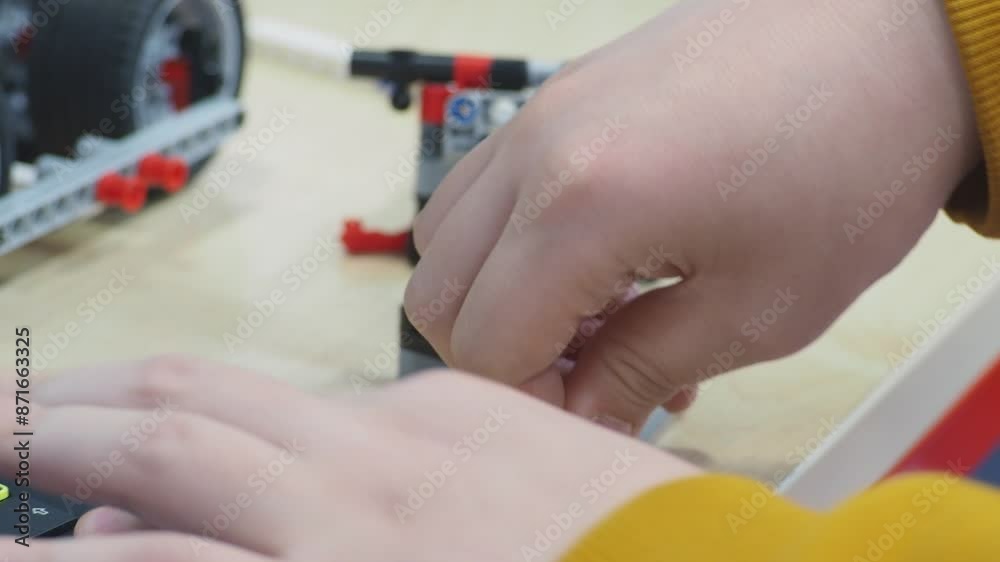 future engineers and designers. boy try to connect wires and assemble mechanism. The robot from the children's designer on the control panel. DIY educational toy. A radio-controlled robot. future engineers and designers. boy try to connect wires and assemble mechanism. The robot from the children's designer on the control panel. DIY educational toy. A radio-controlled robot.