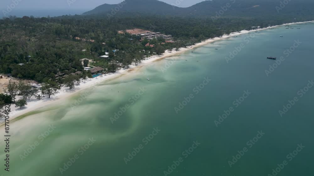Drone shot over the coast of Koh Rong Sanloem island. Paradise Beach. Paradise island in Cambodia. Sunny day. Turquoise water. Saracen Bay, boats on the water. Drone shot over the coast of Koh Rong Sanloem island. Paradise Beach. Paradise island in Cambodia. Sunny day. Turquoise water. Saracen Bay, boats on the water.