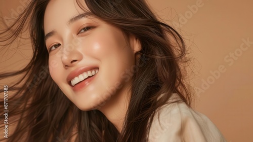 korean beauty influencer long flowing hair warm smile neutral makeup earthy brown background fashionforward look