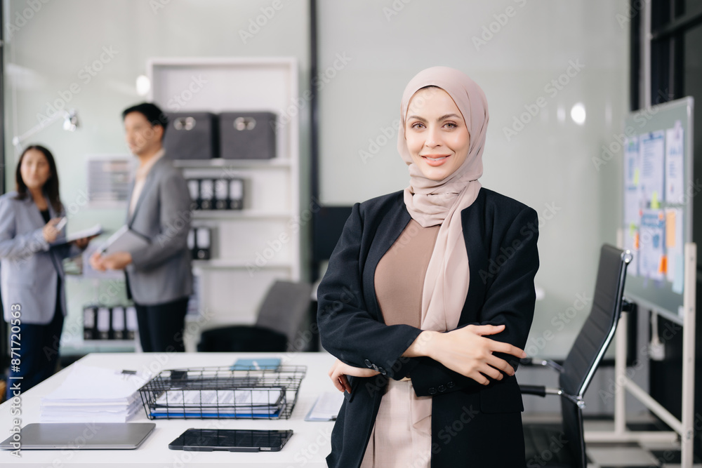 Fototapeta premium Young attractive female office worker business suits smiling at camera in office .
