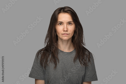 Portrait of a young woman in a white T-shirt. No make up, neutral