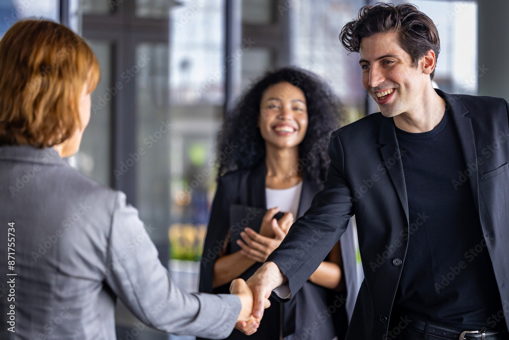 Team of diversity business people having agreement and handshake deal over new strategic strategy project on investment real estate with recognition and applause from other colleagues for partnership Team of diversity business people having agreement and handshake deal over new strategic strategy project on investment real estate with recognition and applause from other colleagues for partnership