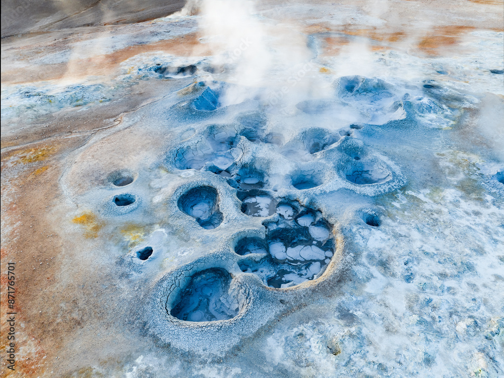 View from above, stunning aerial view of Námafjall Geothermal Area also known as Hverir with smoking fumaroles and boiling mud pots, surrounded by sulphur crystals of many different colours, Iceland.