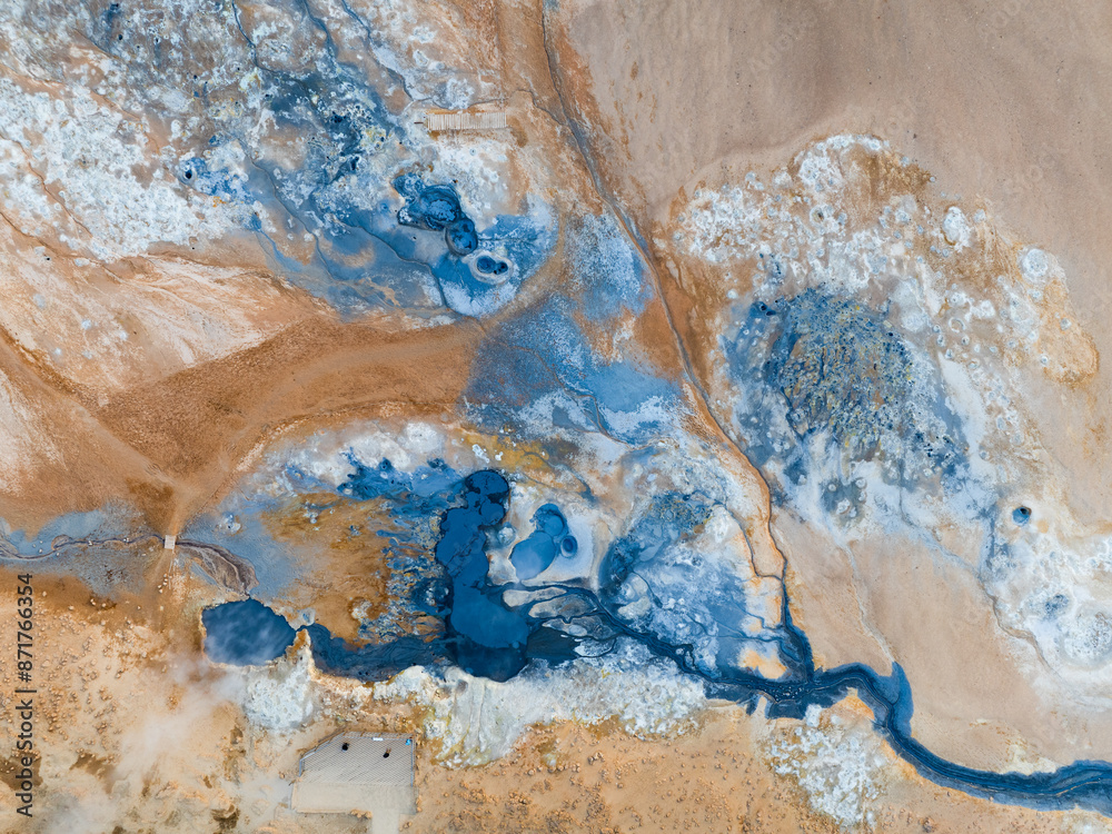 View from above, stunning aerial view of Námafjall Geothermal Area also known as Hverir with smoking fumaroles and boiling mud pots, surrounded by sulphur crystals of many different colours, Iceland.
